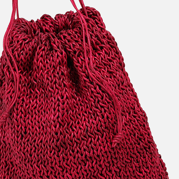 THE POUCH BAG in cherry red — detail of knitted leather texture and drawstring | PROVE'M WRONG