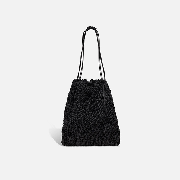 THE POUCH BAG in black — hand-knitted leather pouch with drawstring close by PROVE'M WRONG, front view