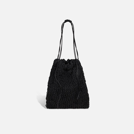 THE POUCH BAG in black — hand-knitted leather pouch with drawstring close by PROVE'M WRONG, front view