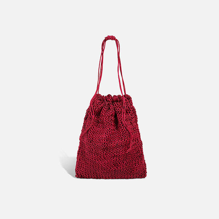 THE POUCH BAG in cherry red — hand-knitted leather pouch with drawstring close by PROVE'M WRONG, front view