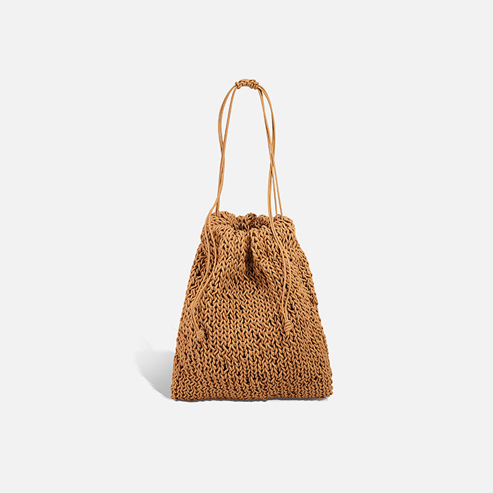 THE POUCH BAG in tan — hand-knitted leather pouch with drawstring close by PROVE'M WRONG, front view