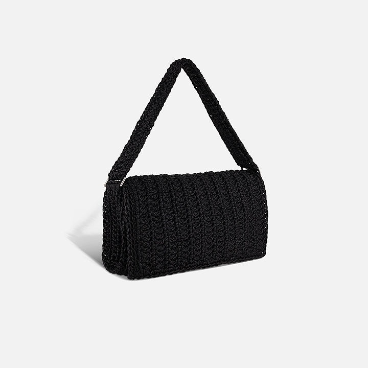 THE BAGUETTE BAG — side view of slim hand-crocheted leather shoulder bag