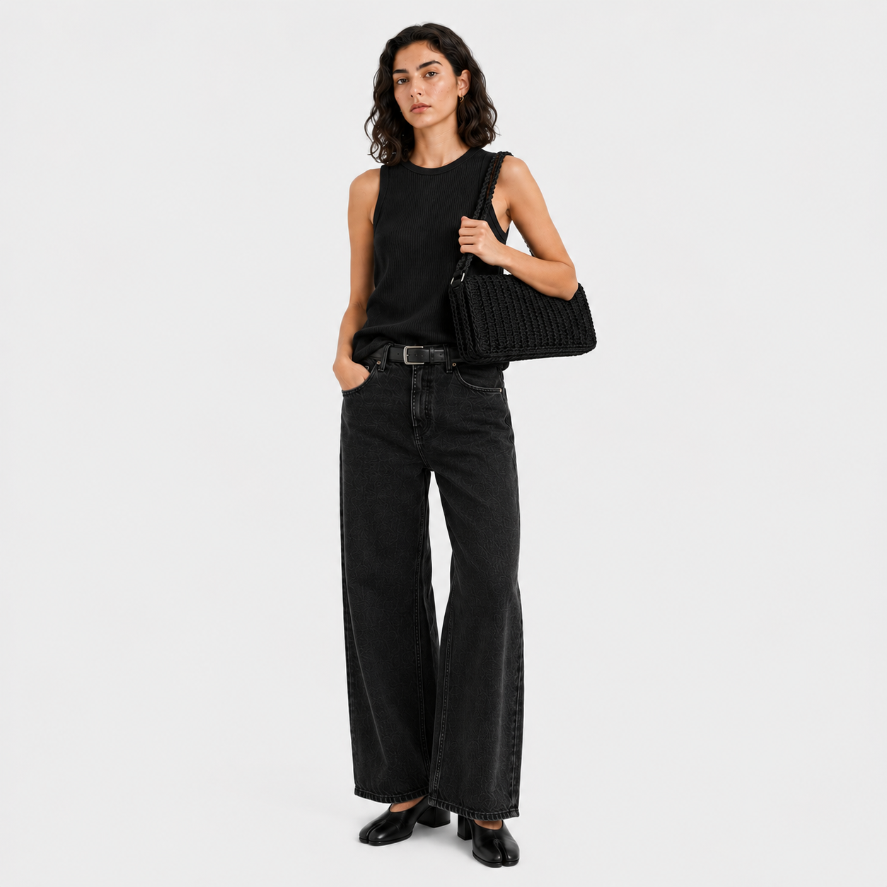 Model holding THE BAGUETTE BAG under arm, hand-crocheted leather shoulder bag | PROVE'M WRONG